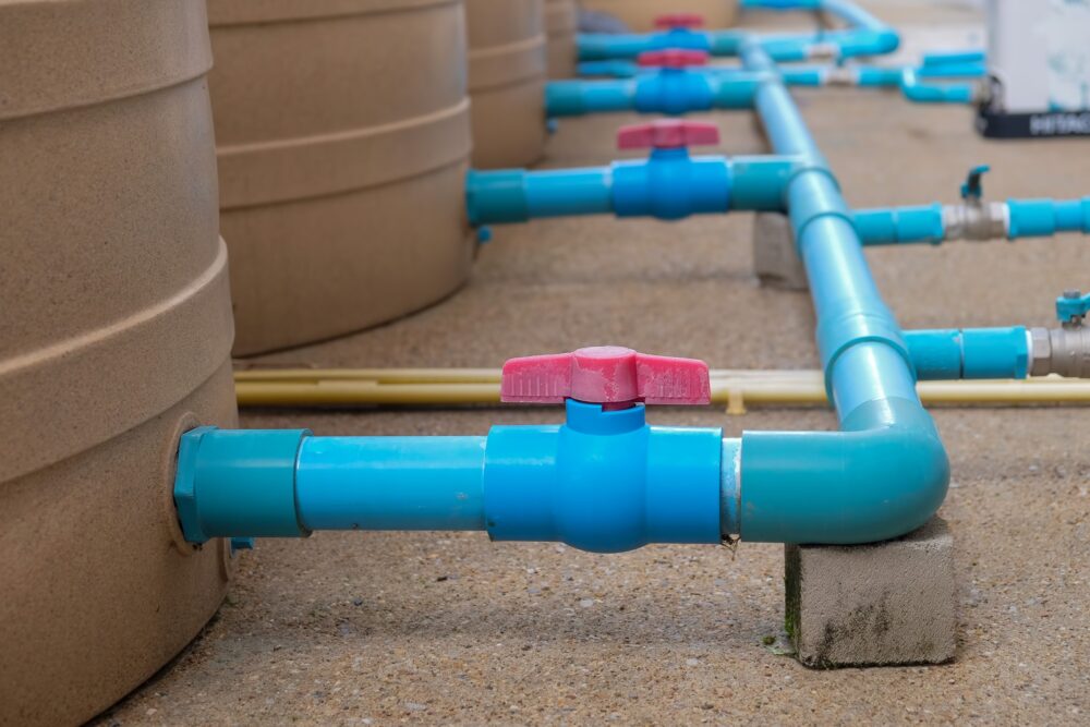 Blue water pipe installation from pump to tank.